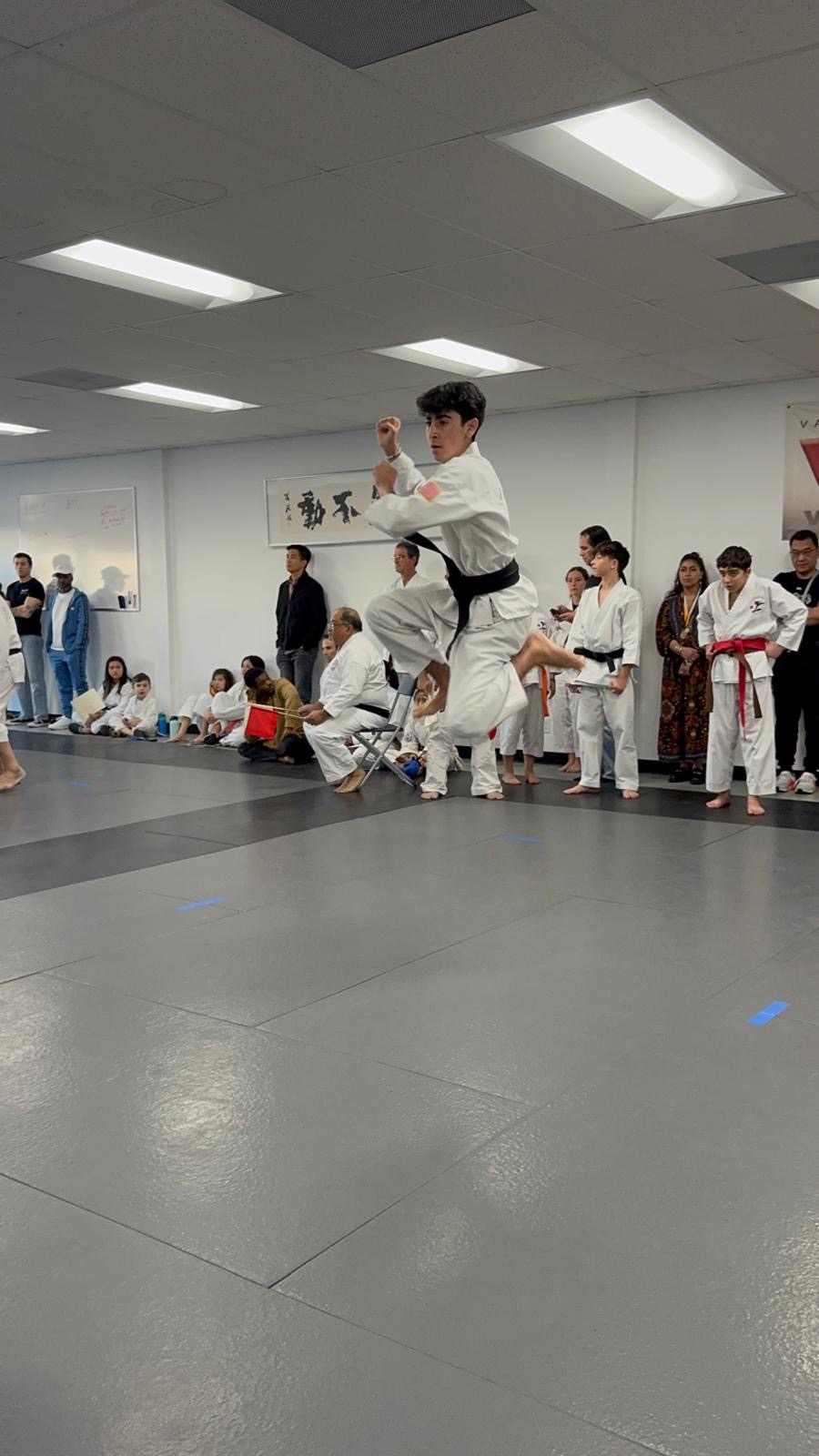 Rokah Karate student mid-jump during tournament kata
